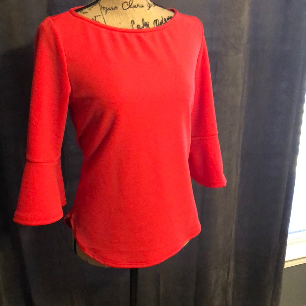 Dark pink blouse with ruffle sleeves.